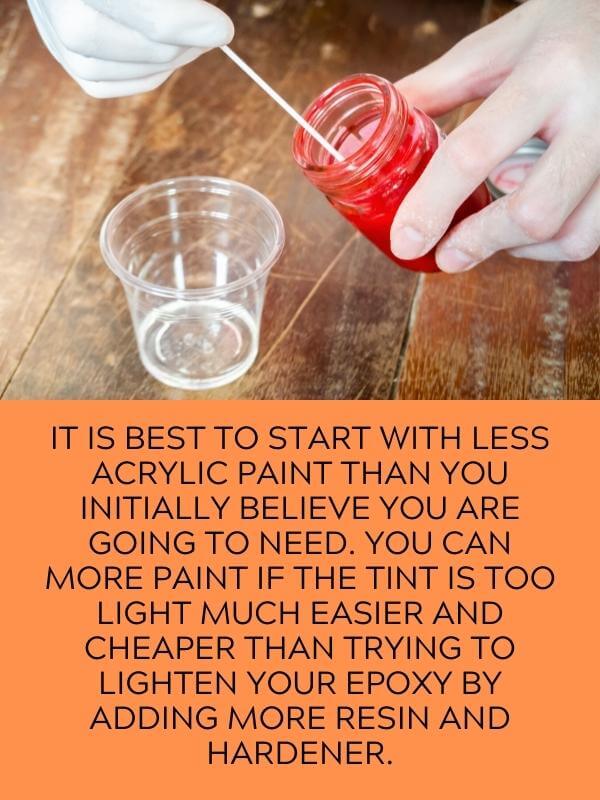 preparing to mix red pain to a resin in a cup